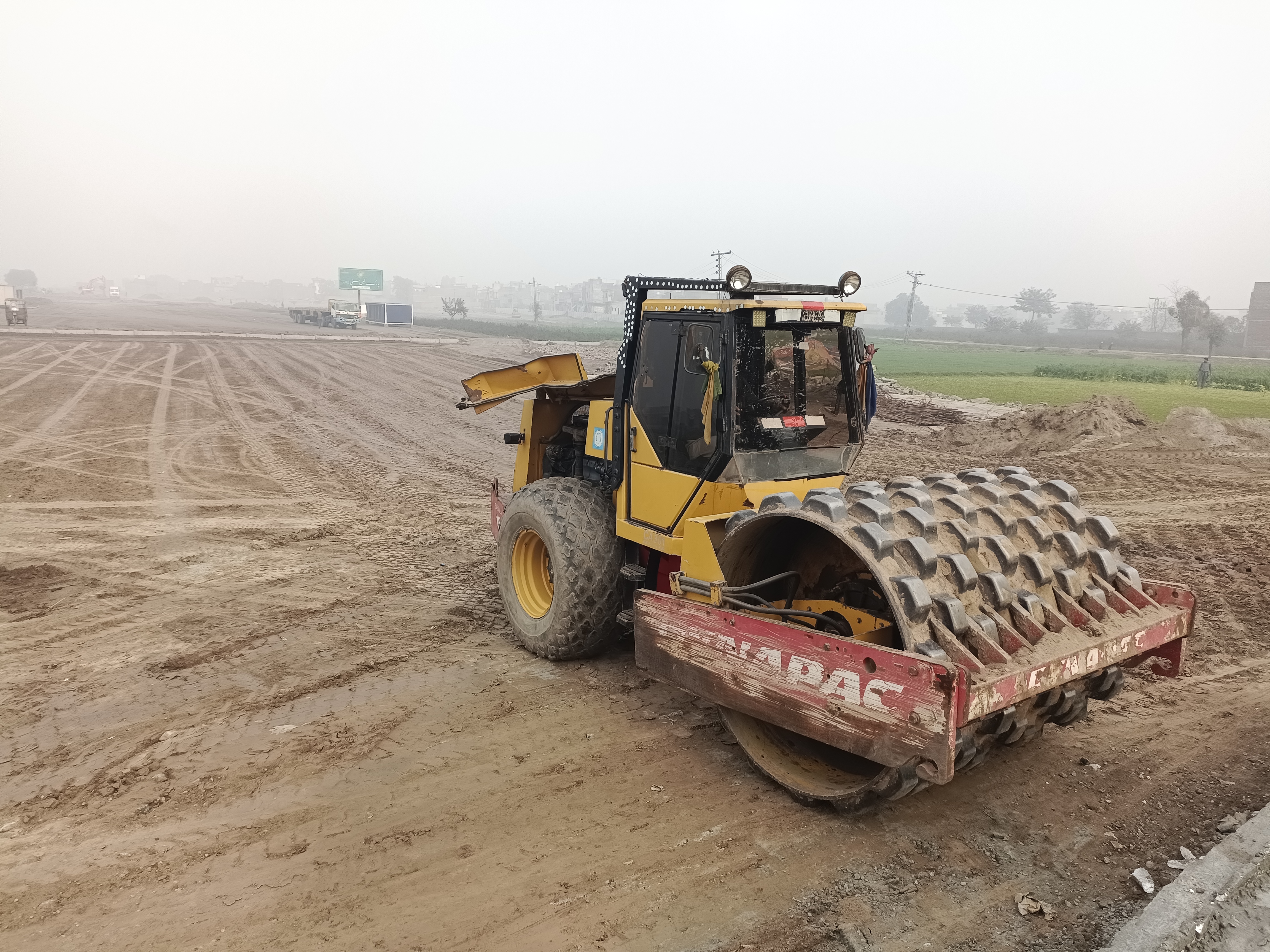 Dynapac road compaction roller working on flat levelled land, January 2023