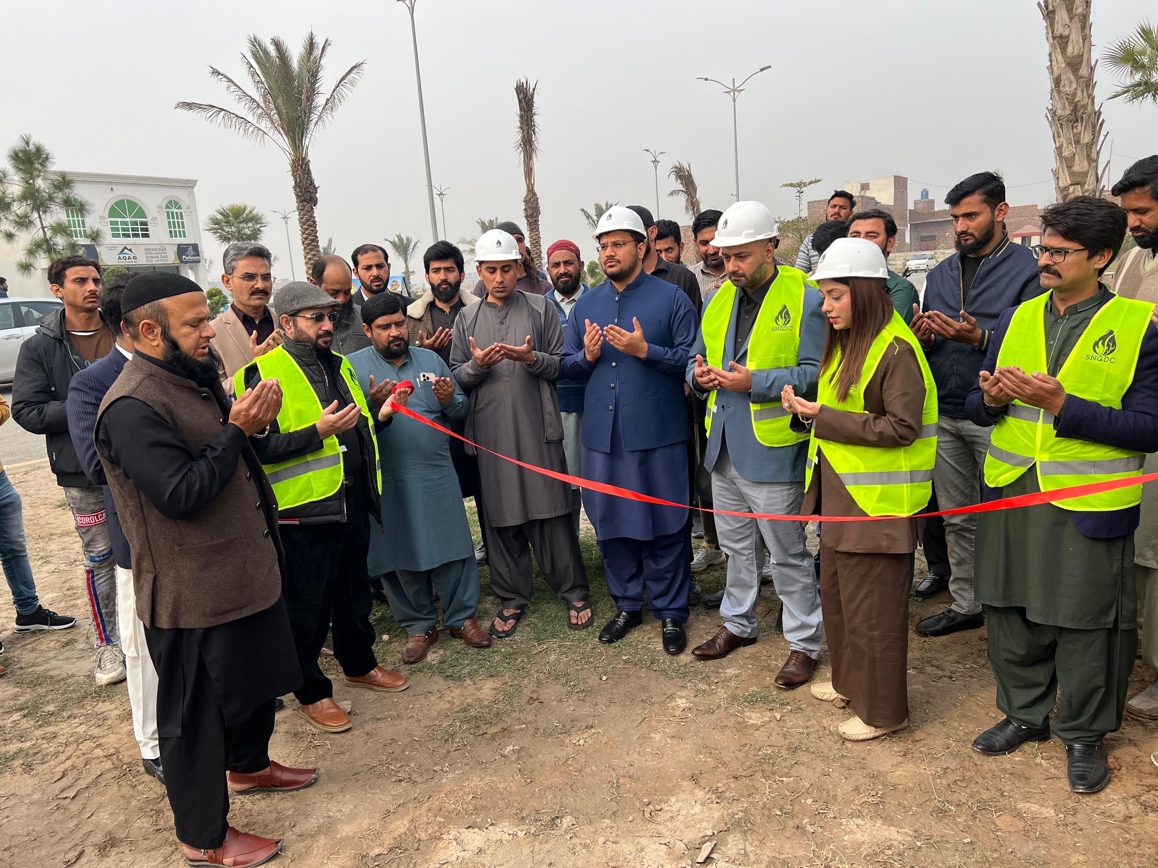 PLC management team in hard hats and high-visibility vests at a ribbon-cutting inauguration ceremony