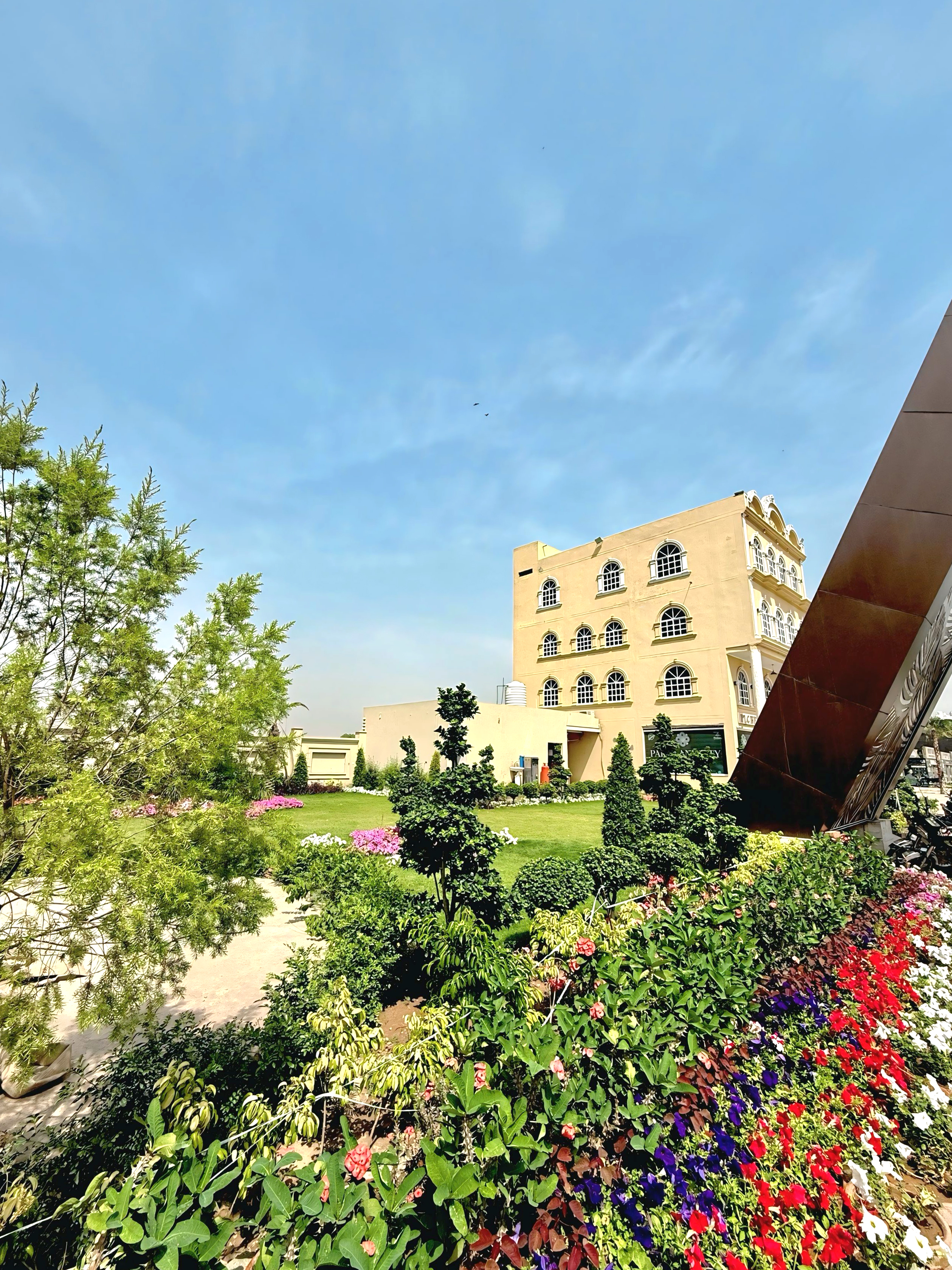 Park Lane City clubhouse building surrounded by colourful gardens